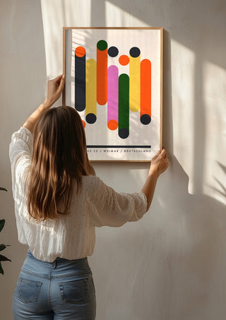 Bauhaus Columns by Neil Stevens being hung on a sunlit wall