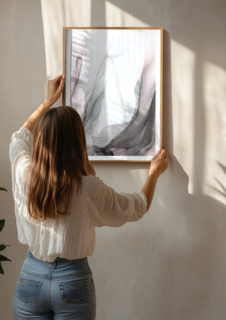 Traces of Wind by Anna Dormir being hung on a sunlit wall