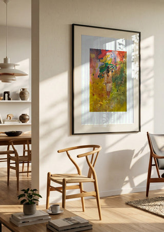 The weight of the world full colour by Madame Petit in a black frame in a bright dining room with wooden chairs