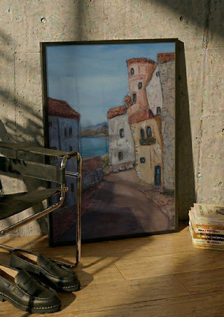 Village Street view, La Azohía, Cartagena, Spain by PaKart in a black frame leaning against a concrete wall by a steel chair