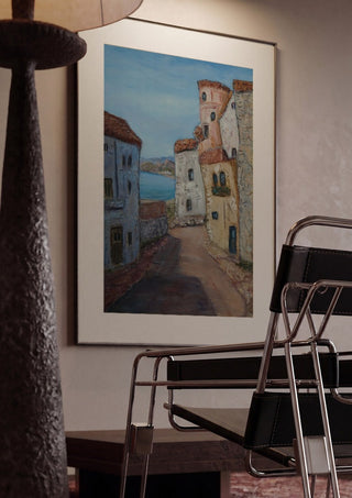 Village Street view, La Azohía, Cartagena, Spain by PaKart framed in a dim room beside a tubular steel chair