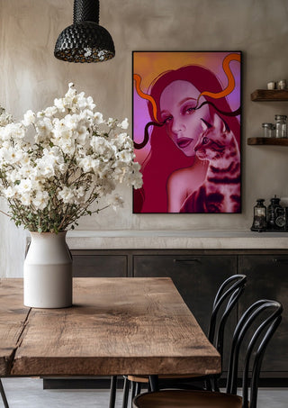 Glow And Purr by Sabrina Rosenblatt in a black frame above a rustic table with white flowers