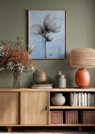 Cotton by Marina Agre above a wooden sideboard on a sage green wall