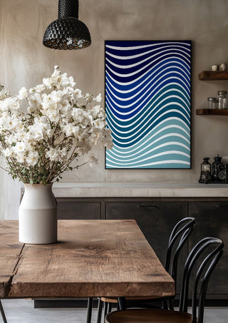 Aallot by Aleksi Allan in a black frame above a rustic table with white flowers