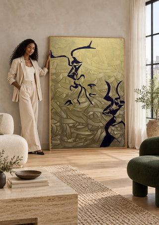Whispers in Gold by Bibi in a tall wooden frame leaning against a wall in a sunlit room
