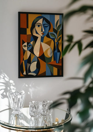 Cubist Woman with Cat and Vase by TimlessArtworks in a black frame above a glass table with crystal glassware