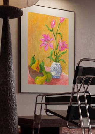 Lillies by Deblina Dey framed in a dim room beside a tubular steel chair