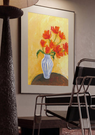 Tulips by Deblina Dey framed in a dim room beside a tubular steel chair