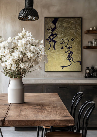 Whispers in Gold by Bibi in a black frame above a rustic table with white flowers