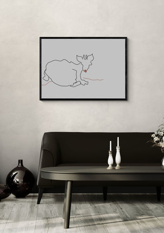 Resting Cat by Eva Hartman in a black frame above a dark sofa with white candlesticks