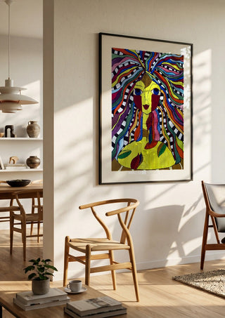 Kaleidoscopic Minds by Bibi in a black frame in a bright dining room with wooden chairs