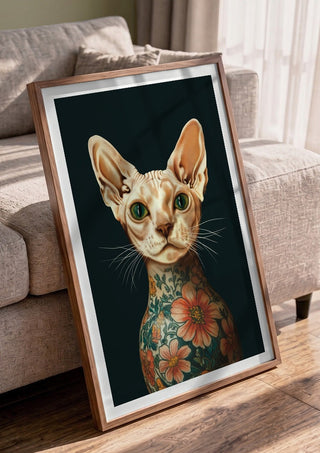 Tattooed Sphynx by Nari in a walnut frame leaning against a grey sofa