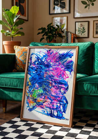 Electric Bloom by Ronald Rumell in a wooden frame beside a green velvet sofa on a chequered floor
