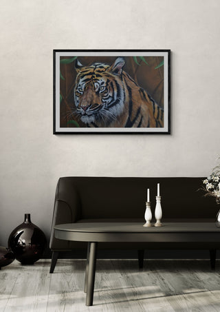 Solo Tiger by Sarah Daniels Art in a black frame above a dark sofa with white candlesticks