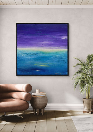 Fragment of Space by Marina Agre in a black frame above a pink armchair beside a palm