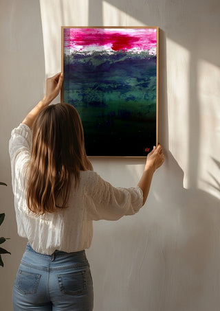 Emerald and Carmine by Marina Agre being hung on a sunlit wall
