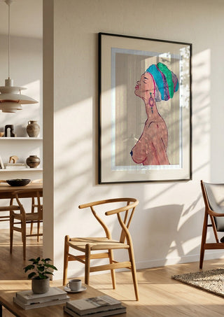 Melanin & Moonlight by Bibi in a black frame in a bright dining room with wooden chairs