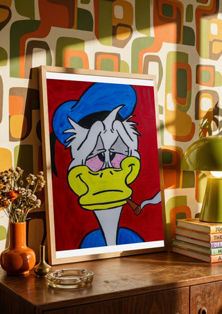 Duck in Dystopia by Bibi in a wooden frame on a sideboard against retro patterned wallpaper
