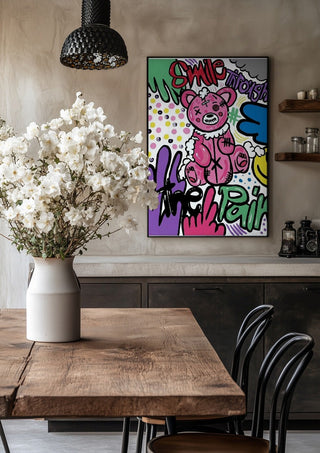 Smile Through The Pain by Bibi in a black frame above a rustic table with white flowers