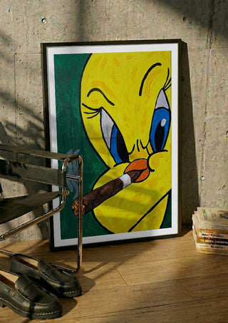 Bad Birdie by Bibi in a black frame leaning against a concrete wall by a steel chair