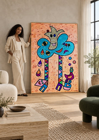 Blue Tree with Faces by Steffi Seiler leaning against a sunlit living room wall beside a woman