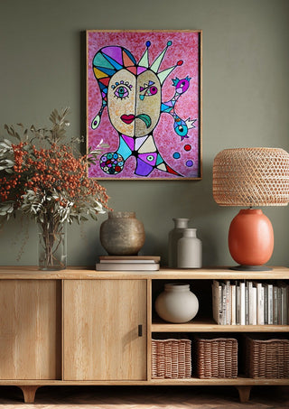 Two Faces and a Crown by Steffi Seiler above a wooden sideboard on a sage green wall