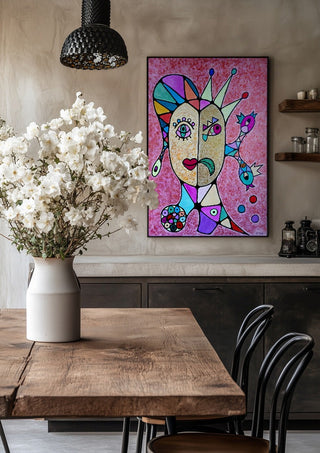 Two Faces and a Crown by Steffi Seiler in a black frame above a rustic table with white flowers