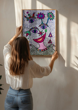 Eyes and Flowers by Steffi Seiler being hung on a sunlit wall