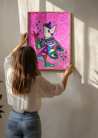 Pink Cat by Steffi Seiler being hung on a sunlit wall