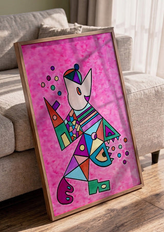 Pink Cat by Steffi Seiler in a walnut frame leaning against a grey sofa
