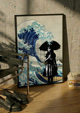 Under the wave by Dikhotomy in a black frame leaning against a concrete wall by a steel chair