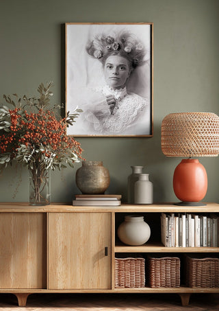 Klara by Bettinafloorphoto above a wooden sideboard on a sage green wall