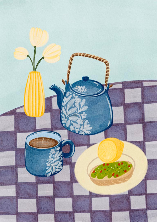 Breakfast table with a teapot, coffee cup, plate of toast with avocado, and vase of flowers on checkered cloth.