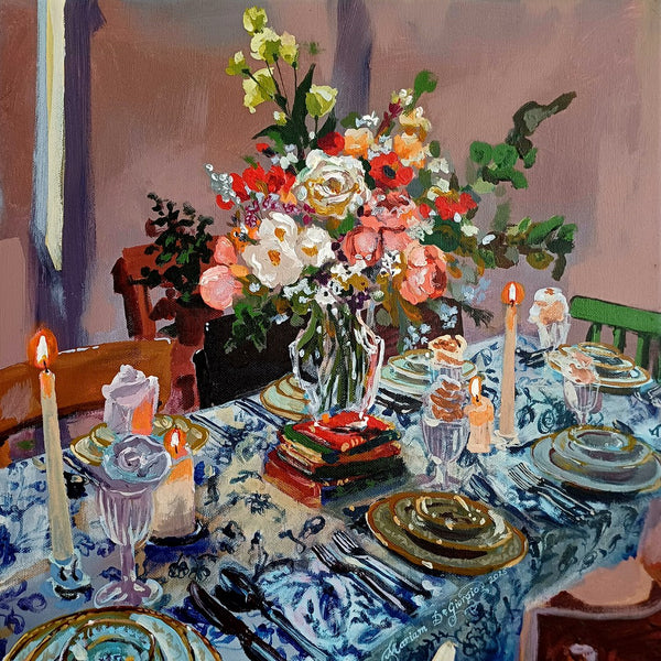 Friday banquet no. II by Mariam De Giorgio — a candlelit table laid with a blue-and-white cloth and a large bouquet of roses and peonies.