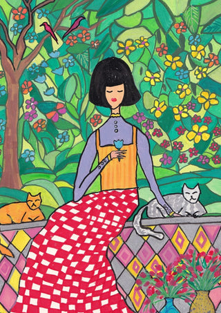 The Garden Wall by Camilla Nilsson - a woman with two cats on a tiled wall in a flowering garden