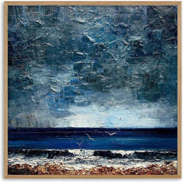 Surf under a Grey Sky by Justyna Kopania - a white line of surf under a heavy grey-blue sky