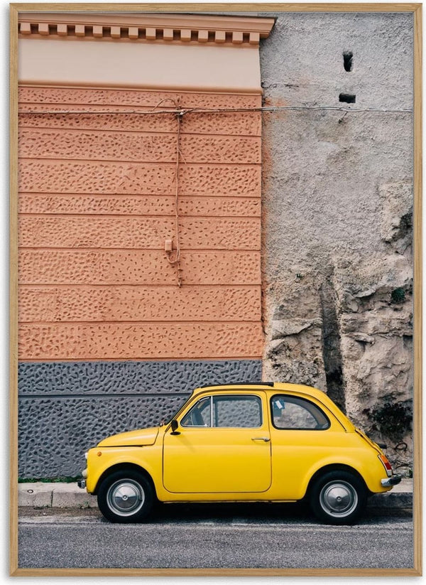 A yellow vintage car parked beside a textured wall on the Amalfi Coast Drive XII.