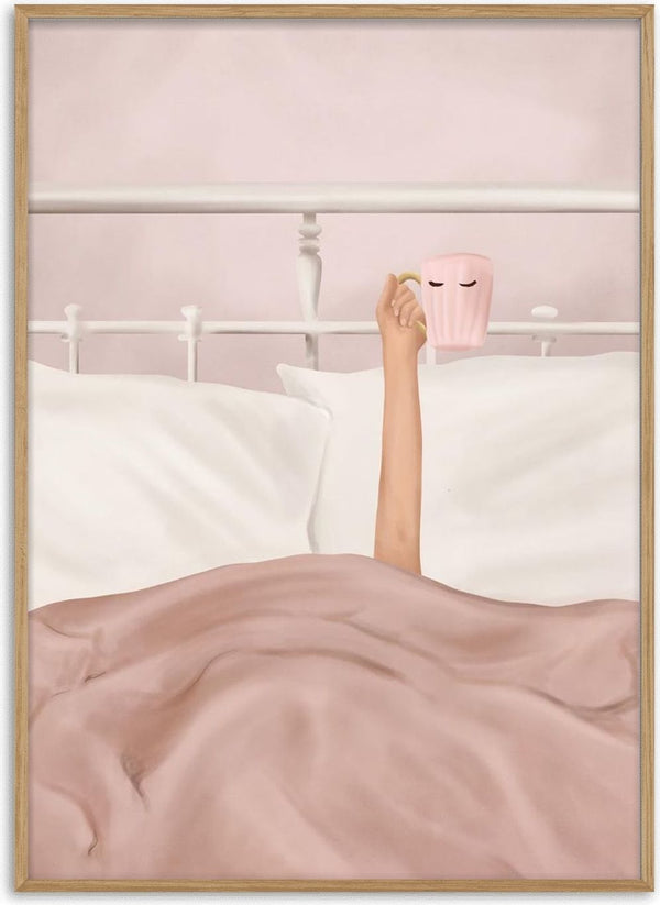 A person in bed lifts a pink Flow Line coffee cup with eyes design, surrounded by soft bedding.