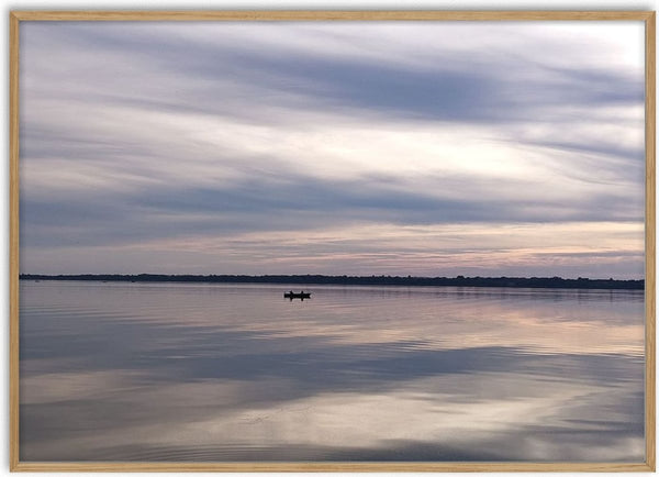 Dusk Reflections by Bora Kőhalmi - banded dusk clouds mirrored in the still water of Lake Balaton with a small boat on the horizon
