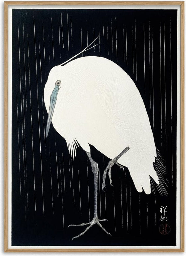 Japanese woodblock print of an egret standing in the rain, by Ohara Koson, on a black background.