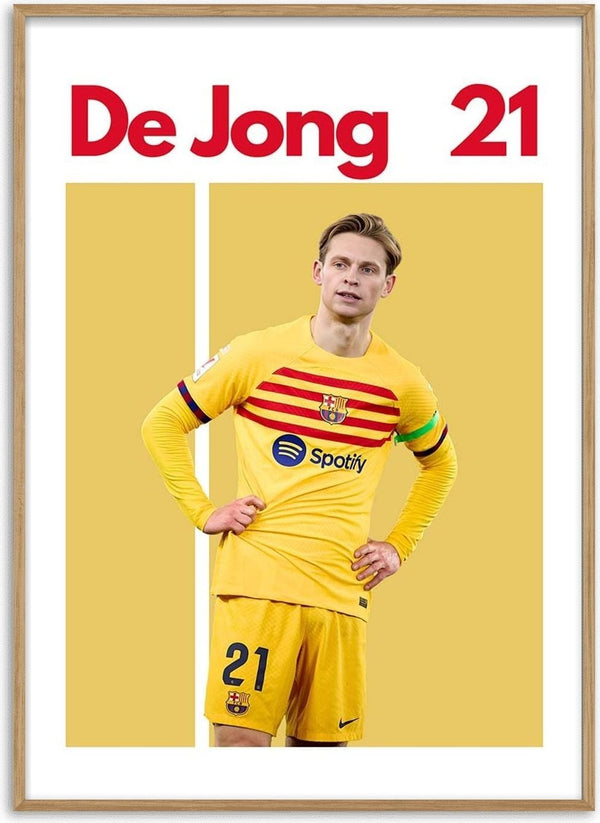 Frenkie de Jong in yellow Barcelona kit with number 21, standing on a graphic football poster.