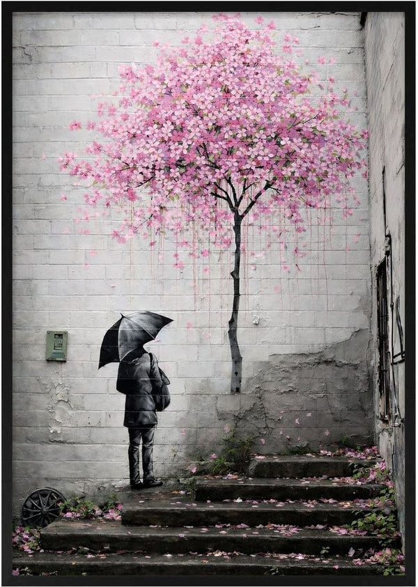 Spring x Banksy by Decker Studios - figure with an umbrella beneath a pink blossom tree on a brick wall