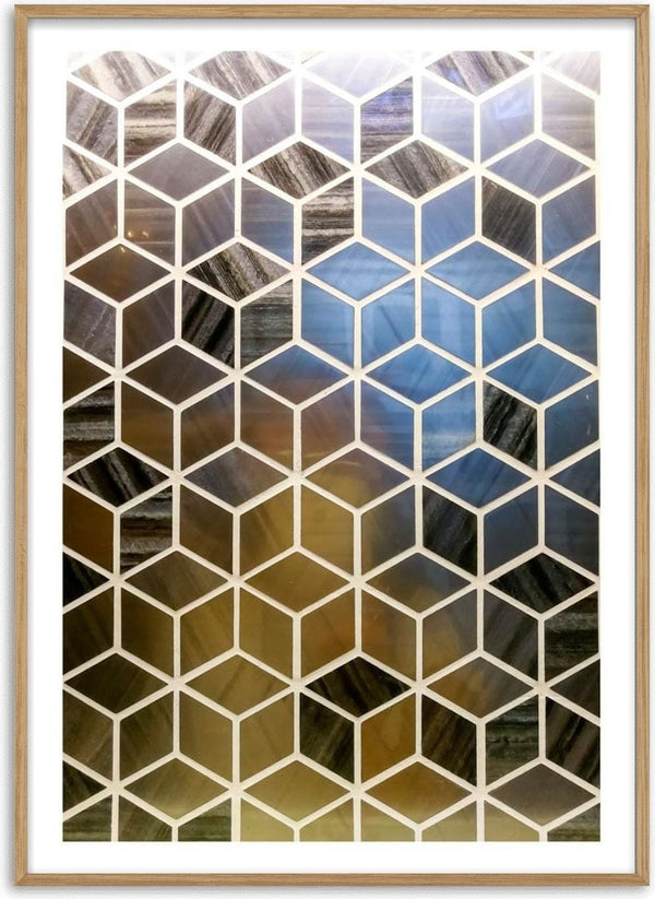 Geometric tile wall design with 3D cube pattern in shades of blue, black, and gold.